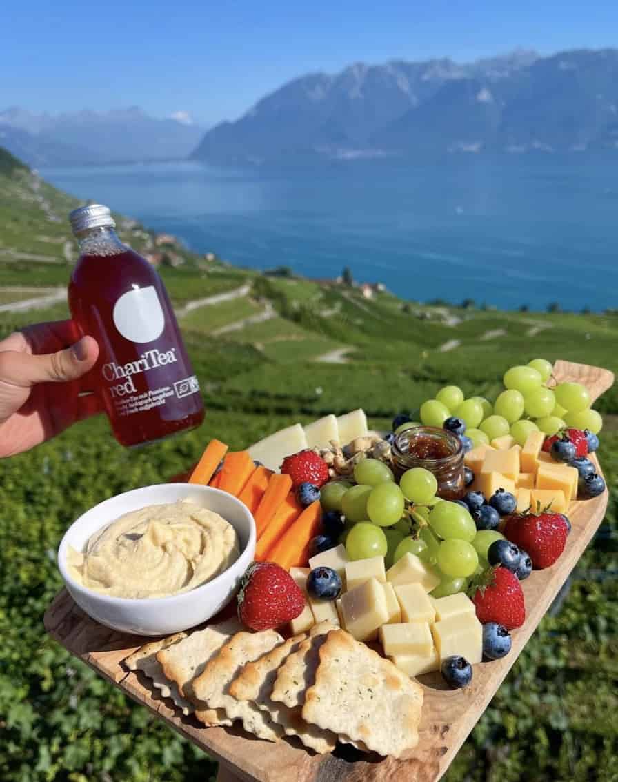 charcuterie board with lake and mountains in background 