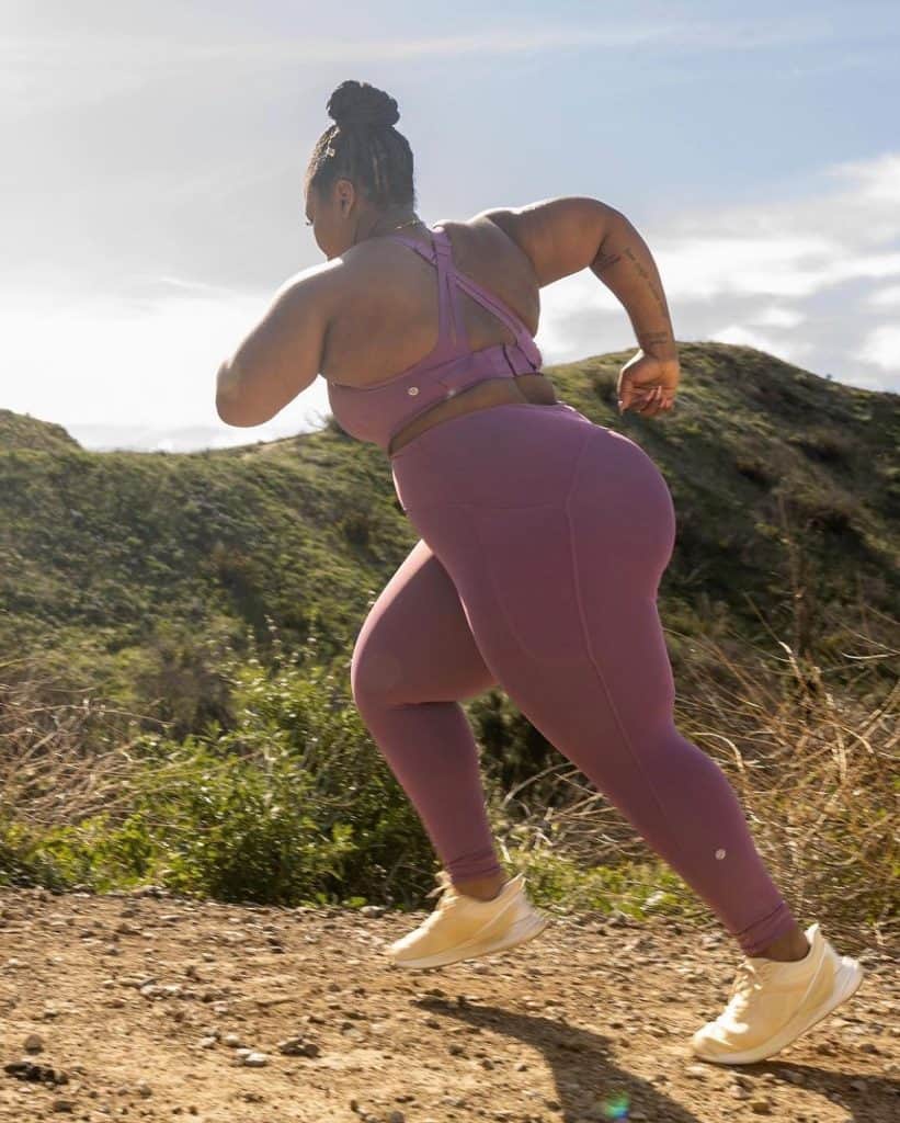 woman running uphill wearing a lululemon bra and leggings